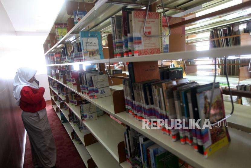 Seorang siswi mencari buku sejarah saat mengikuti belajar bersama di Perpustakaan Nasional, Jakarta, Kamis (27/9).