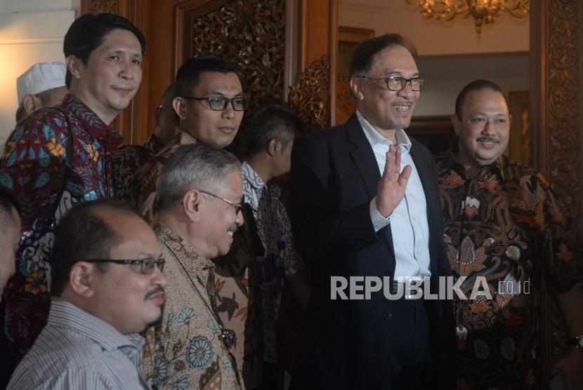 Mantan Wakil Perdana Menteri Malaysia Anwar Ibrahim menyapa wartawan sebelum melakukan pertemuan dengan Presiden ketiga RI BJ Habibie di Jakarta, Ahad (20/5).
