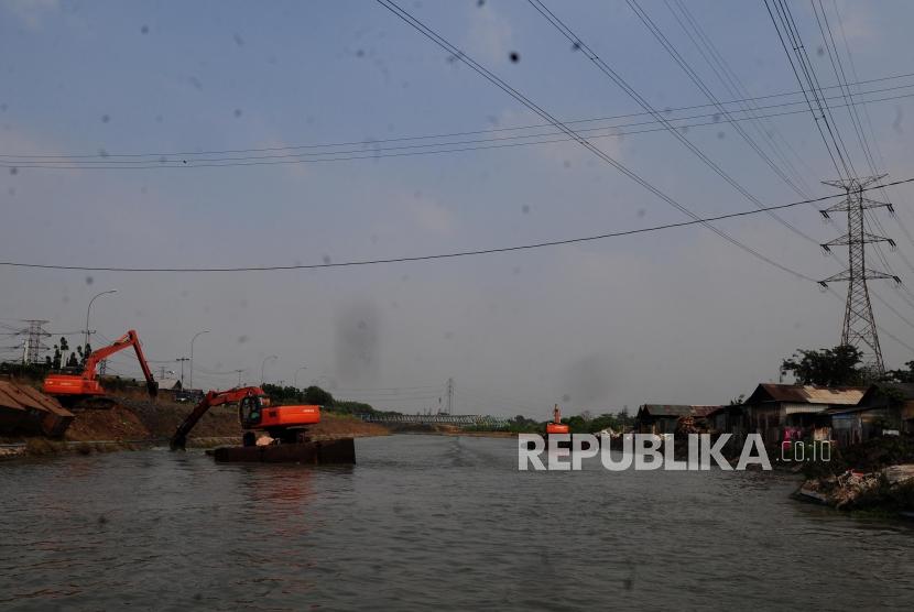 Petugas membersihkan sungai Kalimalang menggunakan alat berat di kawasan Cikarang, Bekasi, Jawa Barat, Kamis (12/7).