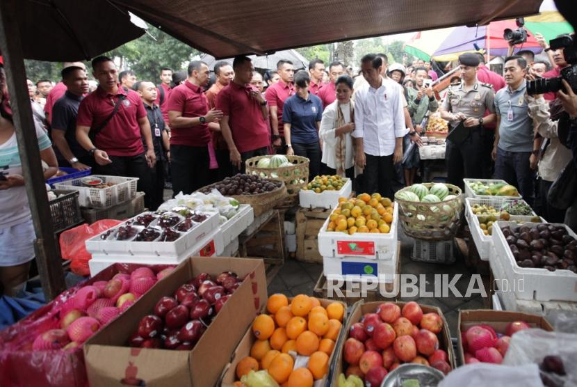 Presiden Joko Widodo beserta ibu negara Iriana Joko Widodo berbelanja buah di Pasar Sukawati, Gianyar, Bali, Jumat (14/6).