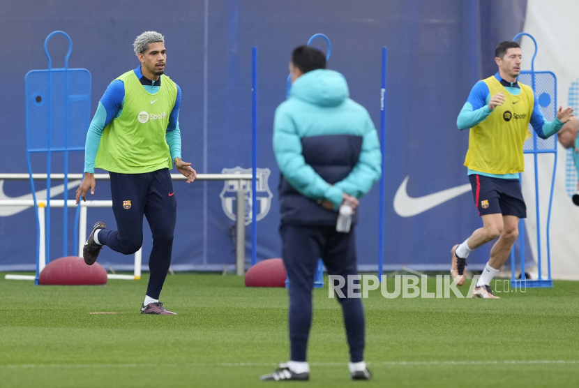 Bek FC Barcelona Ronald Araujo (Kiri) mengikuti sesi latihan tim di kompleks olahraga timnya. 