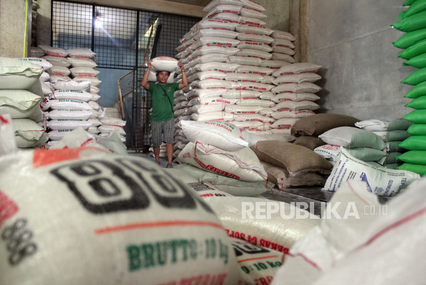 Pekerja memikul karung berisi beras di Pasar Simpang Limun, Kota Medan, Sumatera Utara, Jumat (24/2/2023). Menurut pedagang di pasar tersebut harga beras sejak dua pekan terakhir mengalami kenaikan dari harga Rp9.500 menjadi Rp11.500 per kilogram untuk beras medium, sedangkan untuk beras premium dari harga Rp54.000 menjadi Rp56.000 per kilogram.  