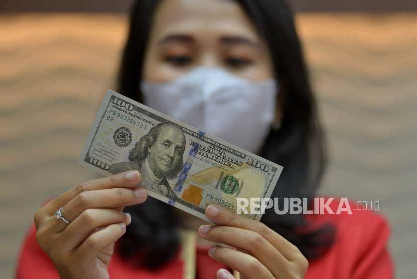 Petugas menunjukkan uang dolar AS di salah satu gerai penukaran mata uang asing di Jakarta, Kamis (29/9/2022). Nilai tukar rupiah terhadap dolar Amerika Serikat (AS) ditutup menguat pada penutupan perdagangan Kamis (29/9/2022) sebesar 4 poin atau 0,03 persen ke level Rp15.262,50 per dolar AS. Prayogi/Republika.