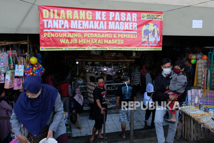 Spanduk wajib memakai masker terpasang di pintu masuk pasar tradisional Ngadirejo, Temanggung, Jawa Tengah, Jumat (22/5/2020). Gugus Tugas Penanganan COVID-19 kabupaten Temanggung menerapkan peraturan wajib memakai masker bagi pengunjung pasar untuk memutus penyebaran COVID-19