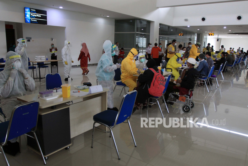 Sejumlah Pekerja Migran Indonesia (PMI) asal Malaysia menjalani Rapid Test saat tiba di kedatangan Internasional Terminal 2 Bandara Juanda, Sidoarjo, Jawa Timur, Selasa (7/4/2020). Sebanyak 156 Pekerja Migran Indonesia (PMI) dari Malaysia yang pulang ke Jawa Timur menjalani rapid test untuk pencegahan penyebaran corona virus atau COVID-19