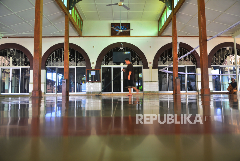Petugas membersihkan lantai Masjid Menara Kudus atau bernama resmi Masjid Al Aqsa Manarat Qudus di Desa Kauman, Kudus, Jawa Tengah, Rabu (13/4/2022). 