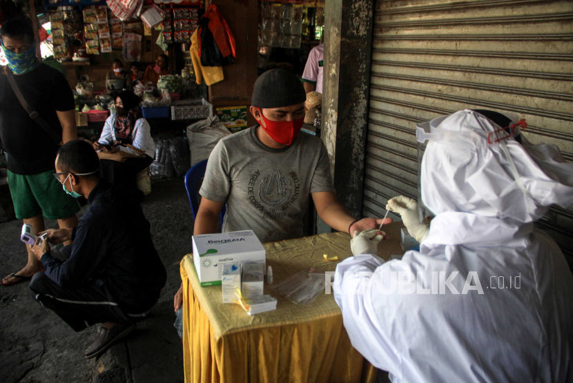 Petugas kesehatan melakukan pemeriksaan cepat atau rapid test COVID-19 di Pasar Larangan, Sidoarjo, Jawa Timur, Rabu (6/5/2020). Dinas Kesehatan kabupaten Sidoarjo melakukan rapid test secara acak terhadap pedagang dan pembeli terkait adanya salah satu pedagang di pasar tersebut positif terpapar virus Corona (COVID-19)