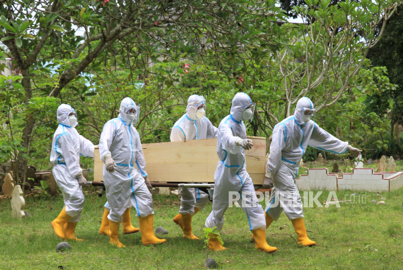 Petugas medis membawa jenazah pasien COVID-19 saat proses pemakaman di Tempat Pemakaman Umum (TPU) Desa Alue Tampak, Kecamatan Kaway XVI, Aceh Barat, Aceh