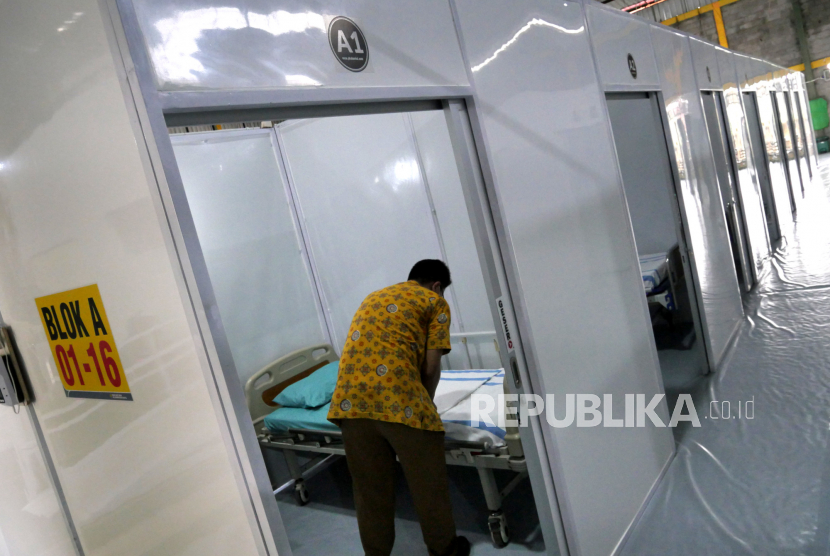 Petugas merapihkan tempat tidur pasien di Shelter Gose Covid-19, Bantul, Yogyakarta, Kamis (18/2). RSU PKU Muhammadiyah menyulap lapangan futsal menjadi shelter pasien Covid-19 OTG. Shelter darurat ini memiliki 32 bilik untuk 16 pasien laki-laki serta 16 pasien perempuan. Selain itu, di sini juga dilengkapi rumah sakit mini serta dokter dan empat perawat yang berjaga.