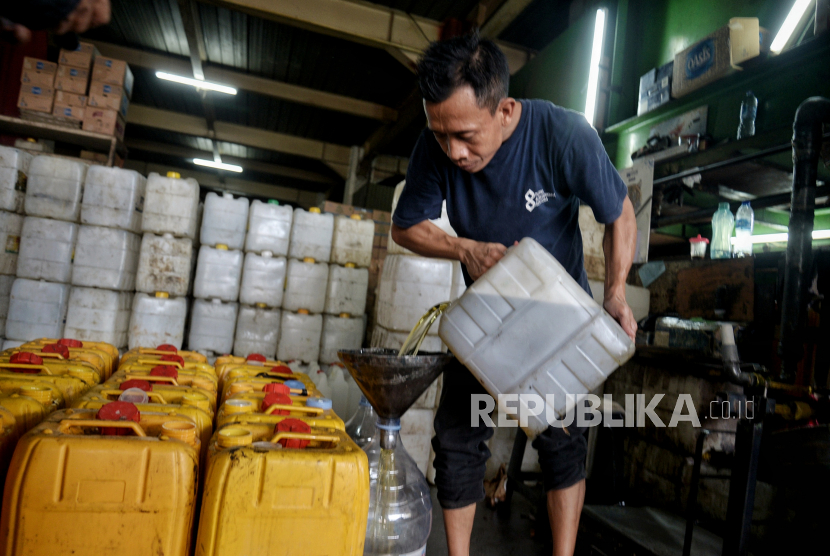 Pedagang menuangkan minyak curah kedalam jerigen milik pembeli di gerainya di kawasan Fatmawati, Jakarta, Rabu (16/3/2022). Menteri Perdagangan menerbitkan aturan kenaikan Harga Eceran Tertinggi (HET) minyak goreng curah jadi   Rp14.000 per liter yang sebelumnya Rp11.500 yang berlaku sejak Rabu (16/3/2022).Republika/Thoudy Badai