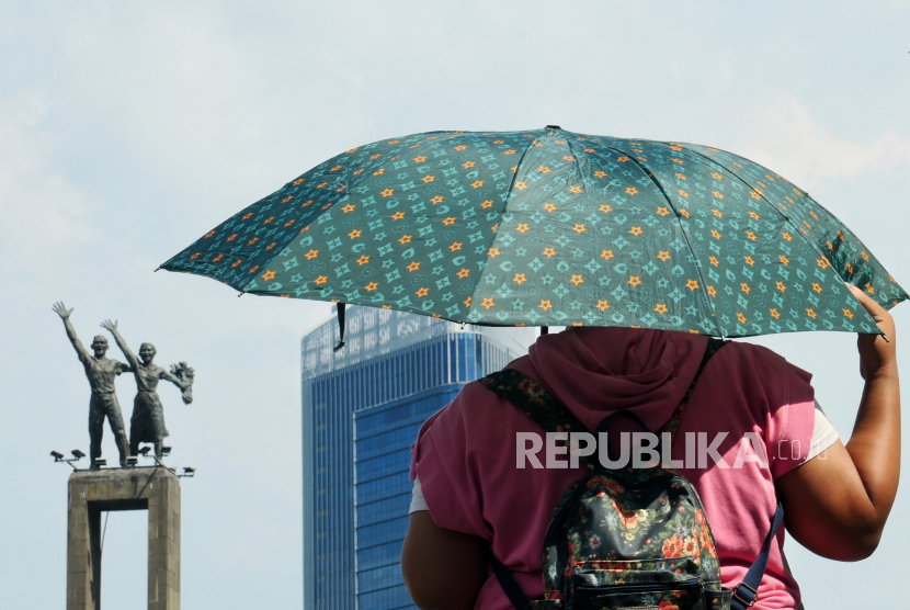 Warga beraktivitas saat cuaca terik di kawasan Bundaran Hotel Indonesia, Jakarta. BMKG memprediksi musim kemarau akan berakhir di sebagian besar wilayah Indonesia mulai akhir Oktober ini.