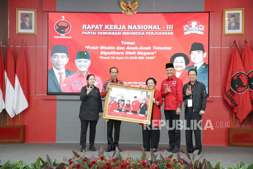 Ketua Umum Partai Demokrasi Indonesia Perjuangan (PDIP), Megawati Soekarnoputri menyerahkan foto pengumuman Ganjar Pranowo sebagai bakal calon presiden (capres) kepada Presiden Joko Widodo (Jokowi). 