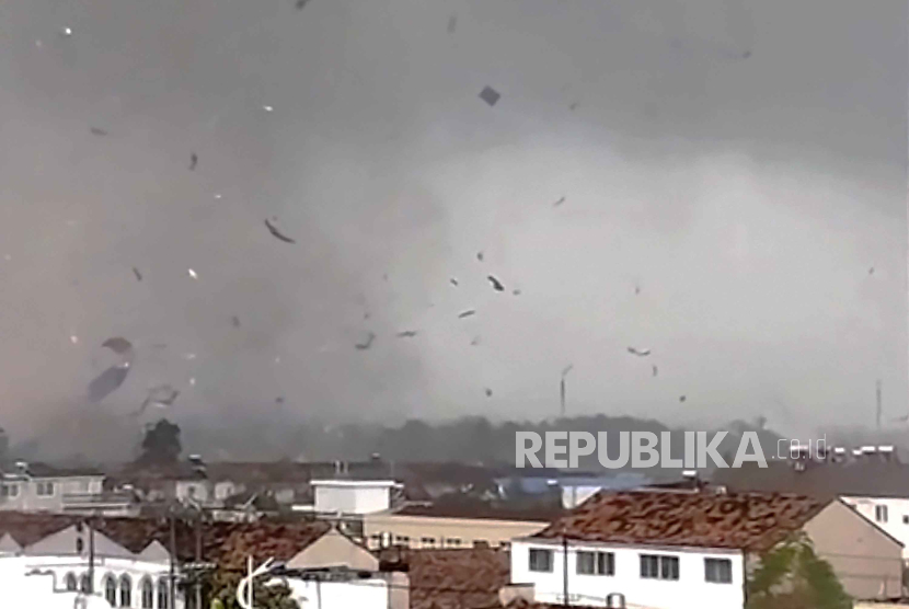 In this frame taken from a video, debris scatters in the sky after a tornado swept through houses in Suqian city in eastern China