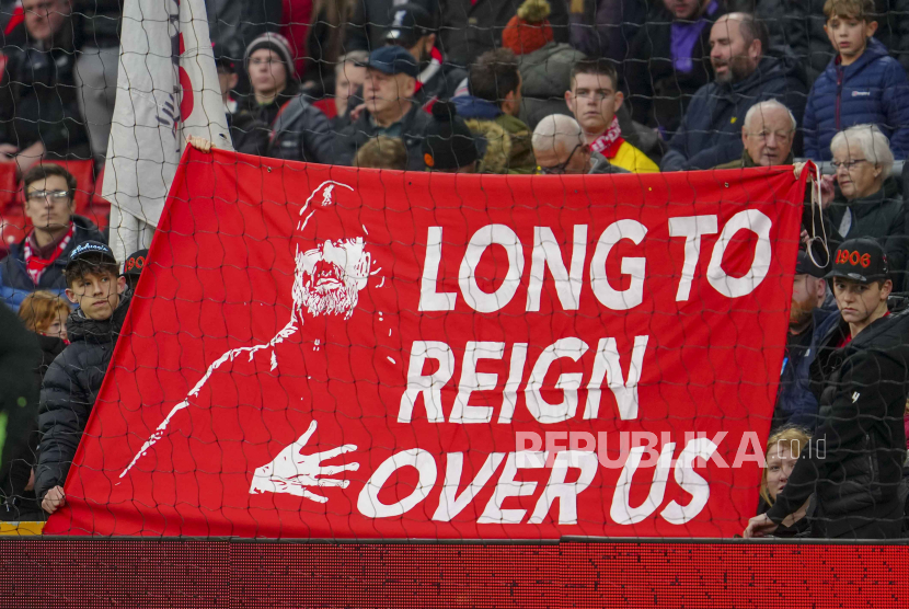 Fans hold a banner depicting Liverpool