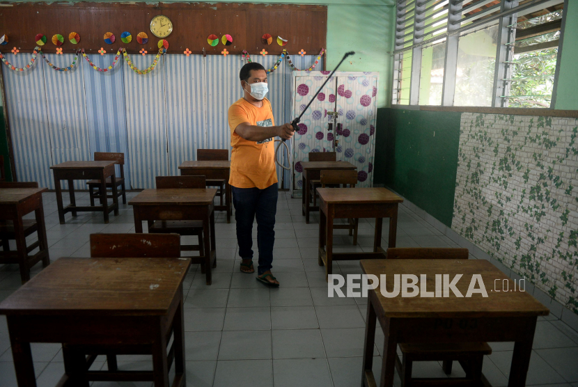 Ilustrasi petugas Sekolah menyemprotkan disinfektan di ruang kelas SDN Petojo Utara 05 Pagi, Jakarta, Sabtu (5/6). Sekolah di Jakarta Utara Masih PTM 50 Persen Hingga 11 Maret