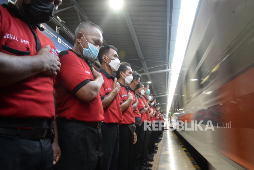 Petugas memberikan salam hormat saat kereta melaju di Stasiun Pasar Senen, Jakarta, Sabtu (23/4/2022). Menteri Ketenagakerjaan Ida Fauziyah mengapresiasi para porter stasiun kereta api yang telah memberikan pelayanan secara baik kepada penumpang.