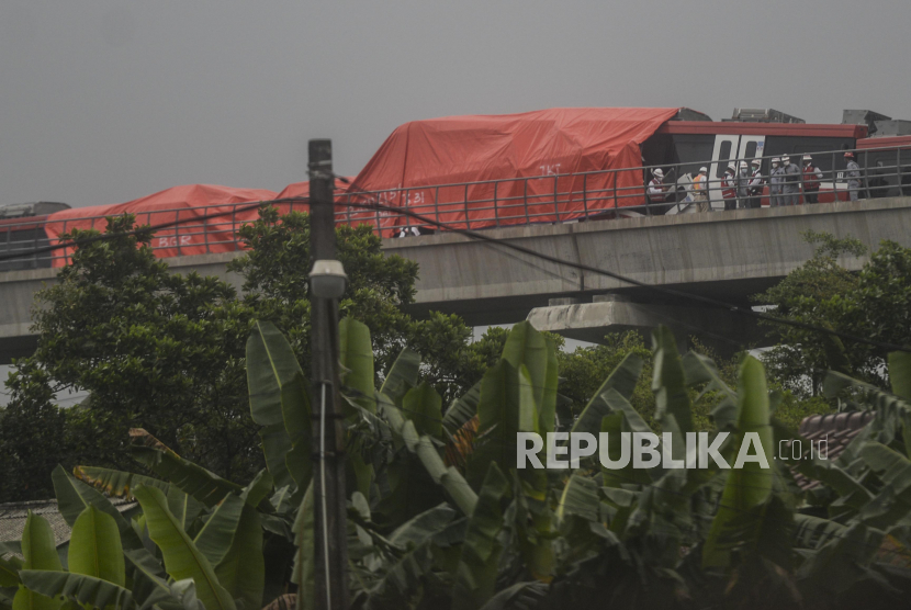 Petugas mengecek kereta LRT yang mengalami kecelakaan di kawasan Cibubur, Jakarta, Senin (25/10). Dua kereta LRT Jabodebek yang masih dalam tahap uji coba mengalami kecelakaan di jalur layang ruas Cibubur-TMII pada pukul 12.30 WIB hingga kini masih dalam tahap pemeriksaan. Republika/Putra M. Akbar