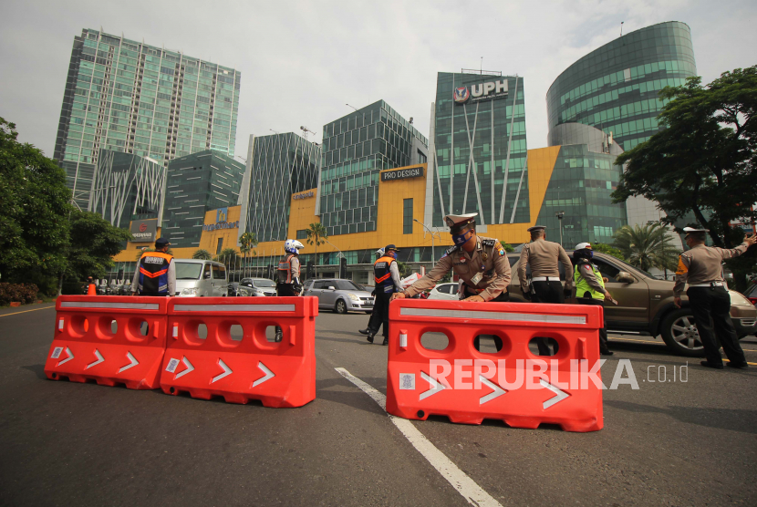 Polisi memasang  water barrier di Bundaran Waru, Surabaya, Jawa Timur, selama masa pemberlakuan PSBB.