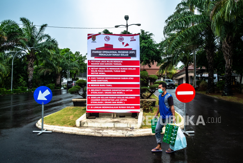 Petugas berjalan mengenakan masker di kawasan Rumah Isolasi Rumah Dinas Wali Kota Semarang, Jawa Tengah, Senin (30/3/2020).