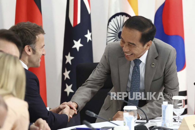 Presiden Prancis Emmanuel Macron (kiri) dan Presiden Indonesia Joko Widodo menyapa para pemimpin negara-negara G7 dan negara-negara undangan dalam sesi sosialisasi KTT G7 di Hiroshima, Jepang, Sabtu (20/5/2023). Dalam pertemuan bilateral bersama Macron, Jokowi menyampaikan sejumlah hal.