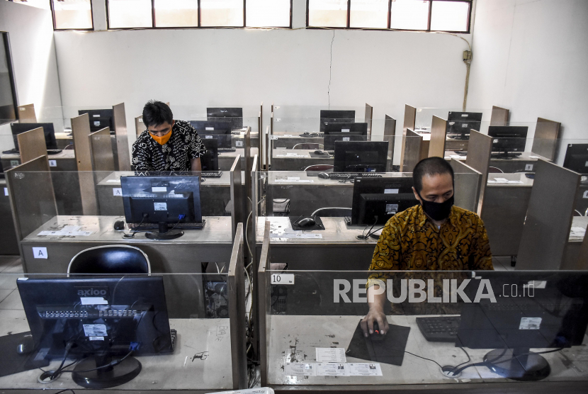 Petugas menyiapkan perangkat komputer untuk Penerimaan Peserta Didik Baru (PPDB) secara daring di SMKN 8 Bandung, Jalan Kliningan, Kota Bandung, Kamis (4/6). 