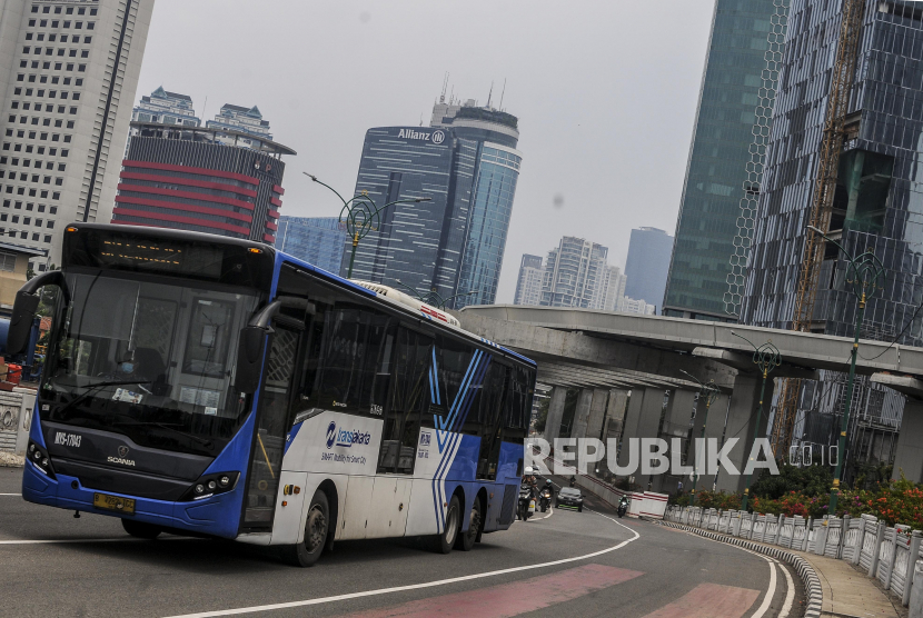 Bus Transjakarta melintasi kawasan Kuningan, Jakarta Selatan, Ahad (11/10). 