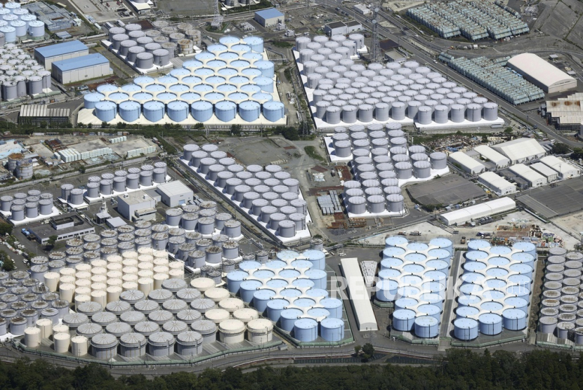 This aerial view shows the tanks which contain treated radioactive wastewater at the Fukushima Daiichi nuclear power plant in Fukushima, northern Japan, on Aug. 22, 2023.  For the wrecked Fukushima Daiichi nuclear plant, managing the ever-growing radioactive water held in more than 1,000 tanks has been a safety risk and a burden since the meltdown in March 2011. The start of treated wastewater release Thursday marked a milestone for the decommissioning, which is expected to take decades.  
