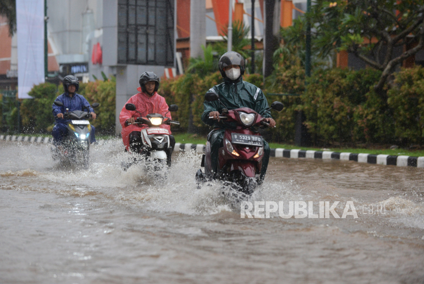 Kendaraan menerobos genangan air yang merendam di Jalan Boulevard Raya, Kelapa Gading. Pj Gubernur DKI Heru Budi mengatakan banjir diupayakan surut dalam 6 jam.