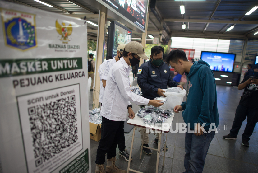 Petugas Badan Amil Zakat Nasional (BAZNAS) memberikan masker gratis kepada calon penumpang KRL di Stasiun Manggarai, Jakarta, Rabu (8/4). kegiatan tersebut dilakukan sebagai bentuk peduli bagi penumpang KRL untuk tetap mengantisipasi penyebaran virus COVID-19 dengan menggunakan masker di tempat umum