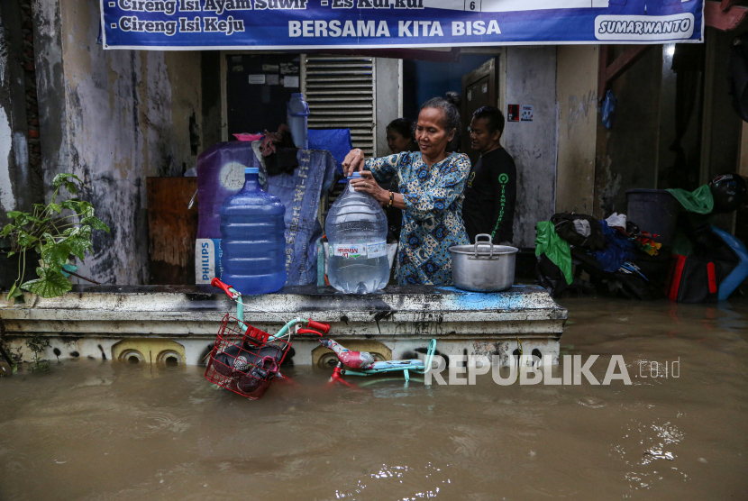 Warga menyiapkan air bersih di depan rumahnya yang terendam banjir di kawasan Jalan Sawah Besar, Semarang, Jawa Tengah, Kamis (14/3/2024). Berdasarkan data Badan Penanggulangan Bencana Daerah (BPBD) Kota Semarang sebanyak 158.137 jiwa di 40 kelurahan terdampak luapan Banjir Kanal Timur (BKT) karena intensitas hujan tinggi pada Rabu (13/3) malam dengan ketinggian air dari 20 sentimeter hingga 80 sentimeter. 