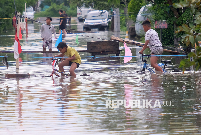 Ilustrasi anak bermain di tengah banjir. Seorang balita Hanyut terperosok selokan saat bermain di tengah hujan.