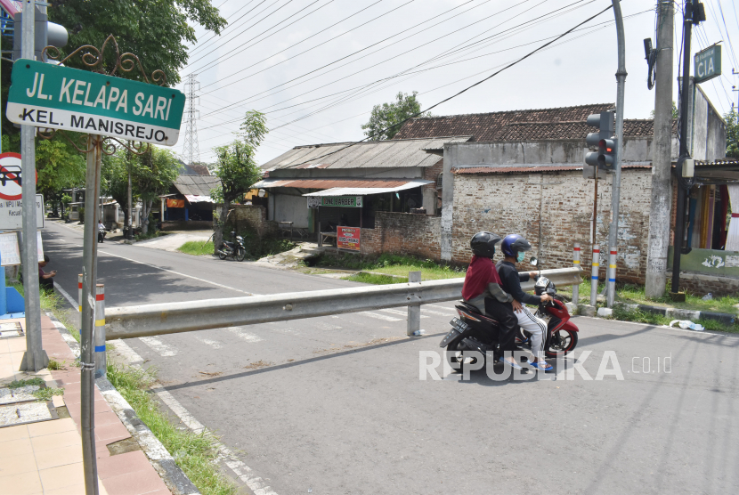 Pengendara berbalik arah ketika terhalang portal besi di Manirejo, Kota Madiun, Jawa Timur, Selasa (31/3/2020). Masyarakat dan Pemkot  setempat membatasi akses masuk sebagian kawasan permukiman guna pencegahan penyebaran COVID-19 atau virus Corona