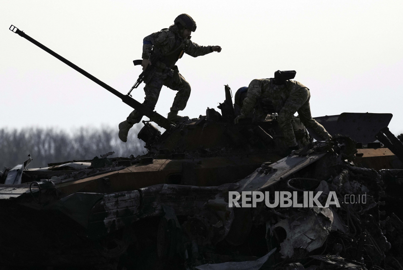  Seorang prajurit Ukraina berjalan di atas kendaraan tempur Rusia. Seorang pejabat Pentagon pada Senin (9/5/2022) mengatakan, ratusan pasukan Ukraina telah menyelesaikan pelatihan senjata baru di Amerika Serikat (AS). 