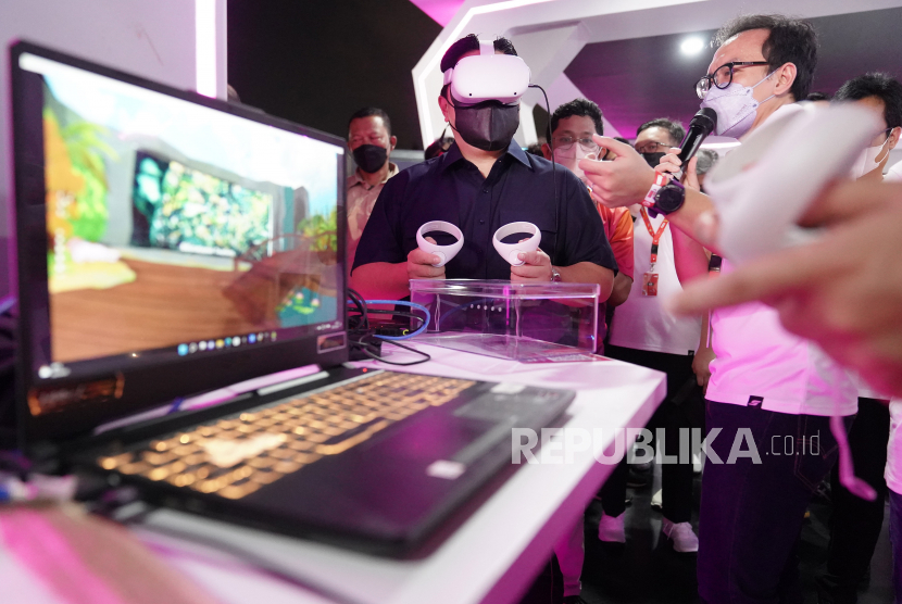 Menteri BUMN Erick Thohir (kiri) mencoba Virtual Reality (VR) saat menghadiri Digiland 2022 di Istora Senayan, Jakarta, Minggu (31/7/2022). Festival musik, seni, kuliner dan pameran teknologi bertajuk Digiland tersebut diselenggarakan dalam rangka merayakan HUT ke-57 Telkom. 