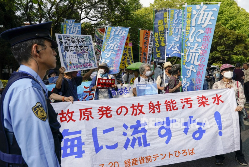 Demonstrators hold placards and banners during a protest against the release of treated wastewater by the Tokyo Electric Power Company (TEPCO) Fukushima Daiichi Nuclear Power Plant into the sea near the TEPCO headquarters in Tokyo, Japan, 20 July 2023. The Japanese government and the International Atomic Energy Agency (IAEA) have approved the release of the treated wastewater into the ocean and said the water will be released this summer. The banner reads Don