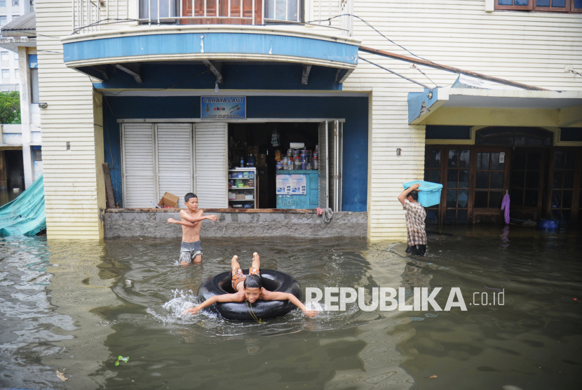 Anak-anak bermain saat banjir rob melanda di Kawasan Pluit Karang Ayu Barat, Jakarta, Senin (16/12/2024). Banjir luapan air laut atau rob tersebut menggenangi salah satu akses jalan untuk memasuki kawasan pelabuhan Muara Angke. Banjir rob dikawasan tersebut mencapai ketinggian sekitar 10 hingga 60 sentimeter (cm) yang berakibat aktivitas warga di sekitar menjadi terhambat. Menurut informasi sudah empat hari banjir rob merendam beberapa tempat di wilayah Jakarta Utara. Sebelumnya Badan Meteorologi Klimatologi dan Geofisika telah mengeluarkan peringatan dini banjir rob pada pada tanggal 11 Desember - 20 Desember 2024.