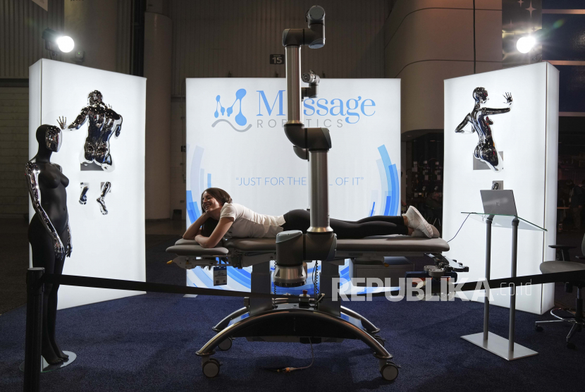 Seorang wanita berbaring di meja pijat robot di stan Massage Robotics selama pameran teknologi CES, Rabu, 5 Januari 2022, di Las Vegas.