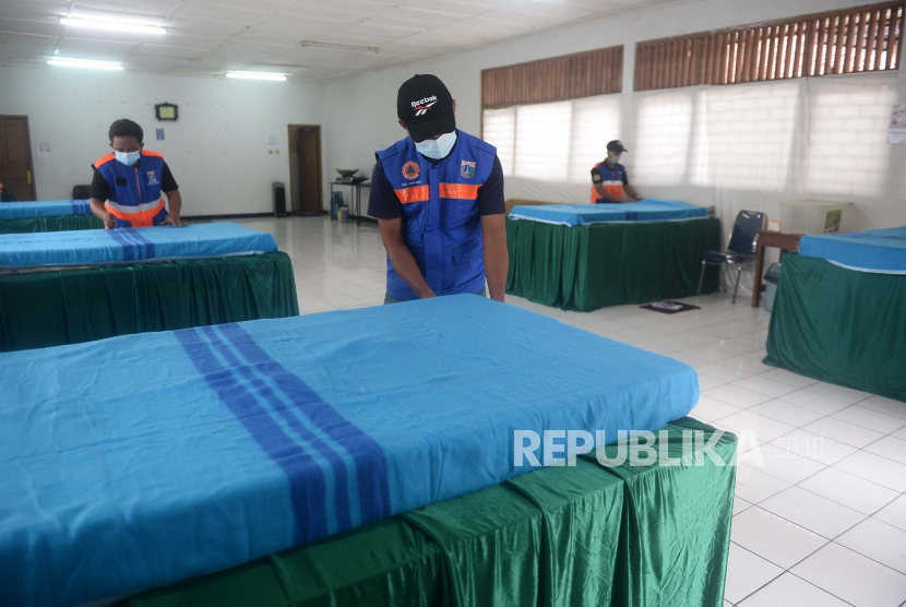 Gugus Tugas RW 003 Kelurahan Pondok Labu merapikan tempat tidur yang akan digunakan untuk isolasi mandiri di Gedung Sasana Krida Karang Taruna, di Jalan Bango III , Pondok Labu, Jakarta, Senin (18/1).