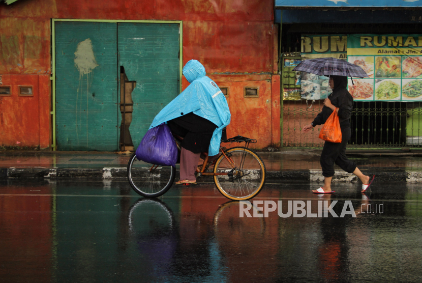 Warga menerobos hujan di Makassar, Sulawesi Selatan, Selasa (24/10/2023).