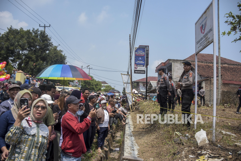 Warga menyaksikan proses olah tempat kejadian perkara di area rumah korban di Jalancagak, Kabupaten Subang, Jawa Barat, Selasa (24/10/2023). Direktorat Reserse Kriminal Umum (Dirkrimum) Polda Jabar melakukan olah tempat kejadian perkara (TKP) ulang kasus pembunuhan  ibu dan anak, Tuti Suhartini  (55) dan Amalia Mustika Ratu (23) yang terjadi pada tahun 2021. Dalam kasus tersebut, Dirkrimum Polda Jabar menetapkan lima orang tersangka yaitu Yosep Hidayah, M Ramdanu, Mimin, Arighi Reksa Pratama dan Abi.