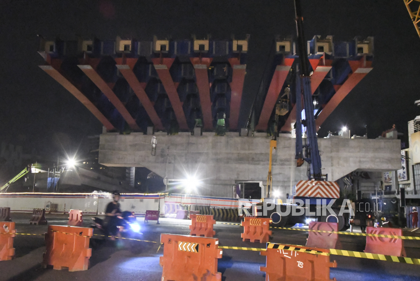 Sejumlah pekerja menyelesaikan pemasangan balok girder (erection girder) Tol Becakayu Seksi II A di Jalan Ahmad Yani, Bekasi, Jawa Barat, Minggu (27/12/2020) dini hari. Pemasangan balok girder proyek jalan Tol Becakayu (Bekasi, Cawang, Kampung Melayu) seksi II A sepanjang 4,1 km dari Jakasampurna menuju Bekasi Timur tersebut dilaksanakan dari tanggal 18 Desember-8 Januari 2020 pukul 23.00 - 04.00 WIB dengan memperhatikan keamanan dan keselamatan pengguna jalan. 