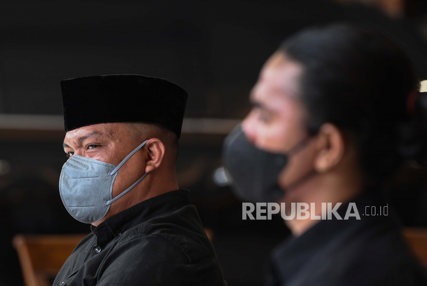 Terdakwa unlawful killing anggota Laskar FPI Ipda M Yusmin Ohorella (kiri) dan Briptu Fikri Ramadhan mendengarkan pembacaan putusan dalam sidang yang digelar secara virtual di Jakarta, Jumat (18/3/2022). Majelis Hakim PN Jakarta Selatan memvonis bebas kedua terdakwa meski dakwaan primer jaksa terbukti, perbuatan terdakwa tidak dapat dikenai pidana karena masuk dalam kategori pembelaan terpaksa dan pembelaan terpaksa yang melampaui batas. 