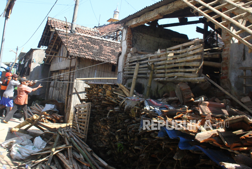 Warga dan relawan merobohkan rumah korban gempa di Majangtengah, Malang, Jawa Timur, Senin (12/4/2021). Hal tersebut dilakukan untuk mengantisipasi jatuhnya korban lagi karena banyak bangunan korban gempa sudah tidak layak huni. 