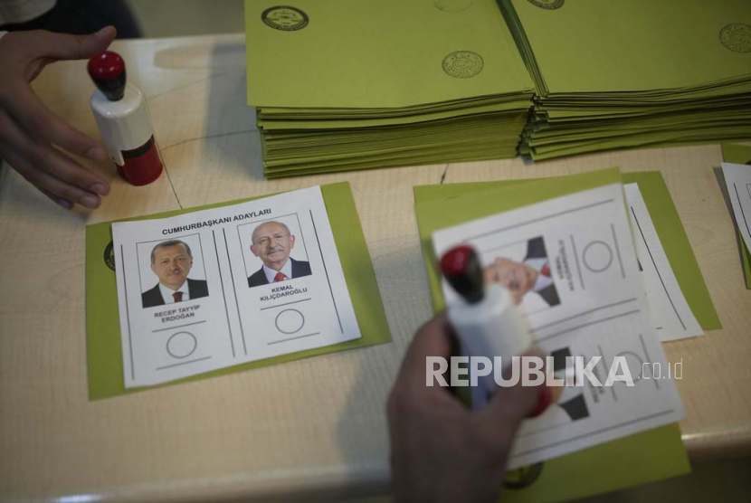 Petugas pemilu menyiapkan surat suara dengan calon presiden di tempat pemungutan suara di Istanbul, Turki,  Ahad, (28/5/2023).