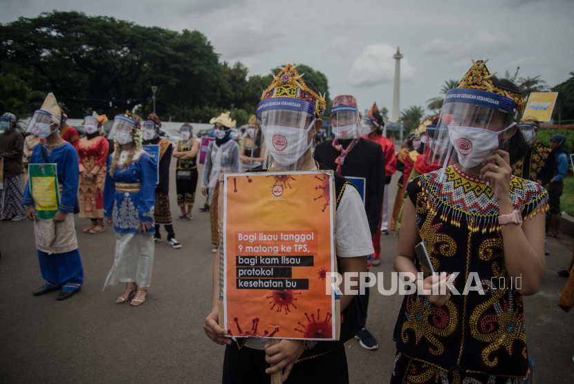 Massa yang tergabung dalam Perkumpulan Gerakan Kebangsaan menggunakan pakaian adat daerah saat melakukan aski kampanye di kawasan Monas, Jakarta, Senin (7/12). Aksi tersebut mengimbau seluruh elemen masyarakat untuk menggunakan hak pilihnya serta menerapkan protokol kesehatan dalam rangka menyambut pesta demokrasi Pilkada 2020 yang berlangsung pada 9 Desember 2020 mendatang. Republika/Thoudy Badai