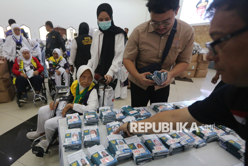 Jamaah calon haji kloter 1 Jakarta mengambil paspor setibanya di Asrama Haji Pondok Gede, Jakarta, Kamis (1/5/2025). Sebanyak 393 jamaah calon haji kloter 1 mulai masuk ke Asrama Haji Pondok Gede Jakarta sebelum bertolak ke tanah suci untuk menjalani rangkaian ibadah haji.
