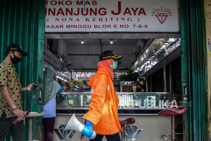 Petugas berada di kawasan pasar untuk melakukan sosialisasi kewajiban menggunakan masker bagi pedagang saat beraktivitas di Pasar Minggu, Jakarta (ilustrasi)