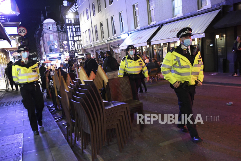Anggota polisi berpatroli  saat memantau pembatasan jam operasional  di Soho, London, Inggris, Kamis (24/9).