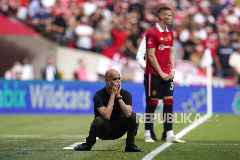 Manchester City head coach Pep Guardiola gestures during the English FA Cup final soccer match between Manchester City and Manchester United at Wembley Stadium in London, Saturday, June 3, 2023. (AP Photo/Dave Thompson)