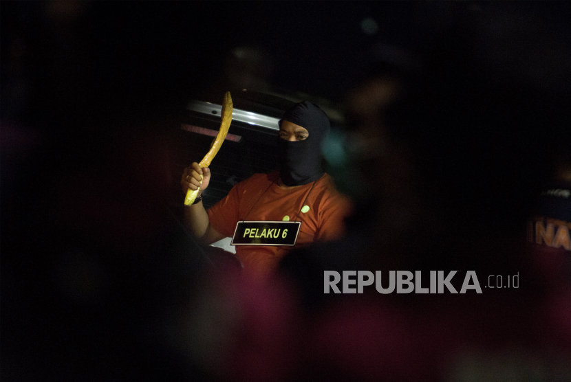 Anggota tim penyidik Bareskrim Polri memperagakan adegan saat rekonstruksi kasus penembakan enam anggota laskar Front Pembela Islam (FPI) di Karawang, Jawa Barat, Senin (14/12/2020) dini hari. Rekonstruksi tersebut memperagakan 58 adegan kasus penembakan enam anggota laskar FPI di tol Jakarta - Cikampek KM 50 pada Senin (7/12/2020) di empat titik kejadian perkara. 